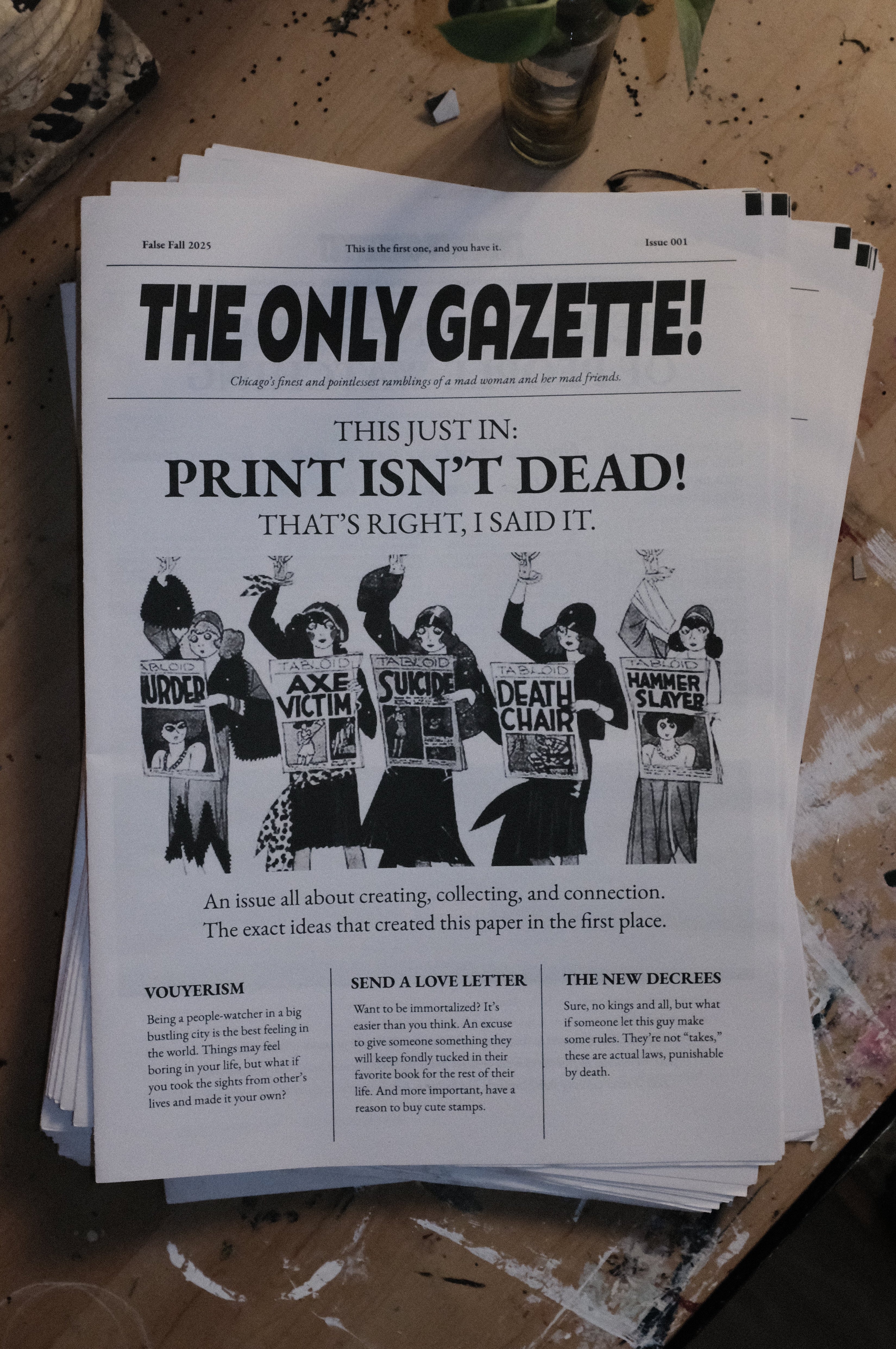 Stack of newspapers titled 'The Only Gazette!' on a wooden surface.