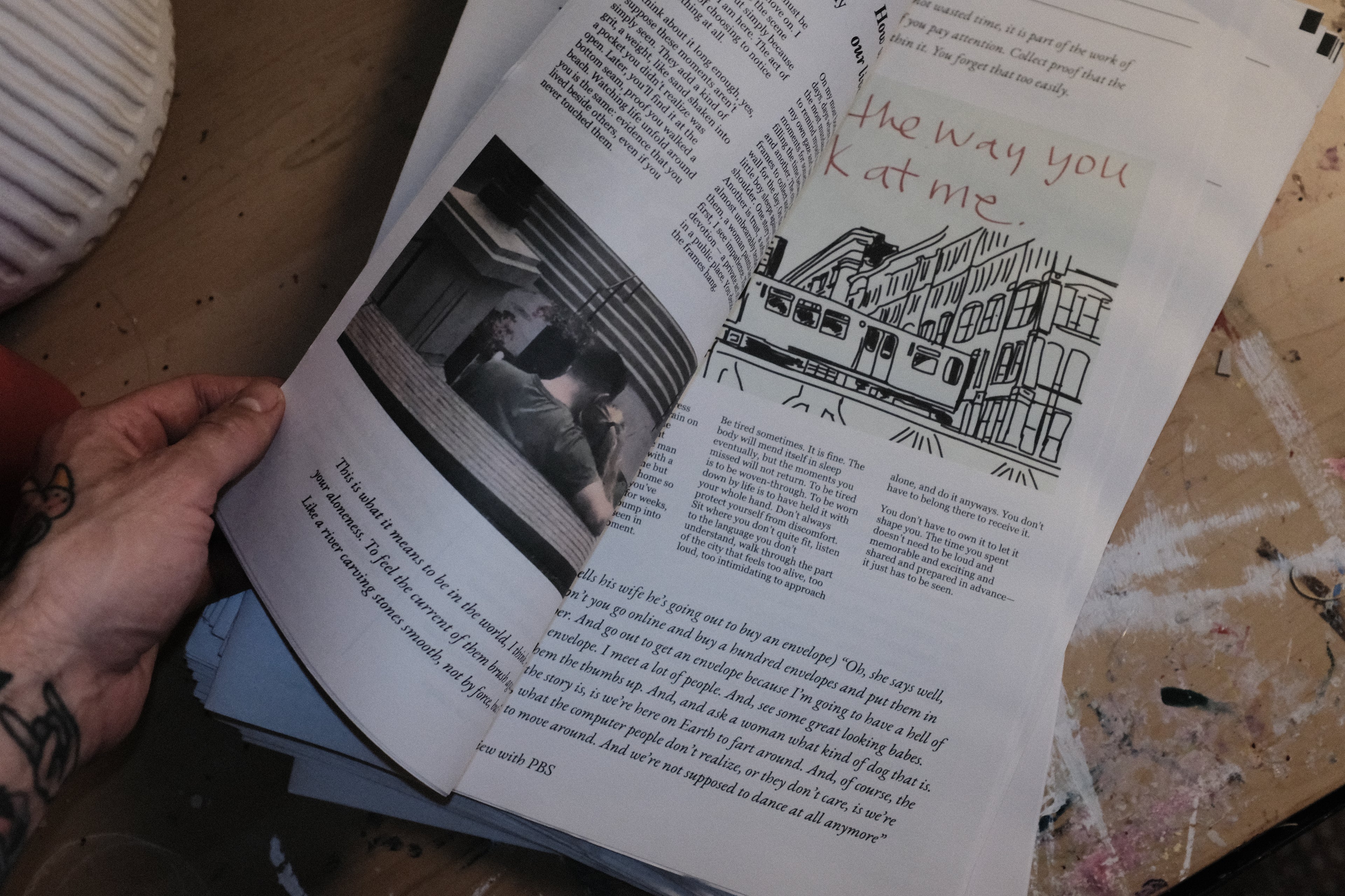 Open book with text and images on a wooden surface